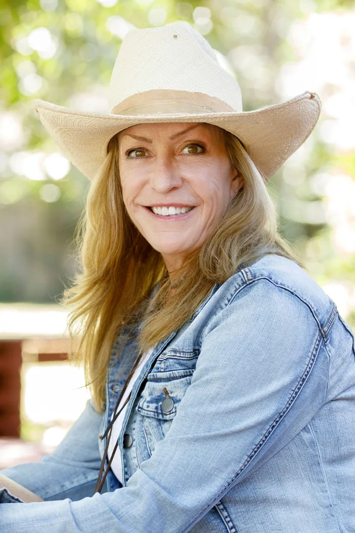 Jodi Kelly wearing a cowboy hat and denim shirt